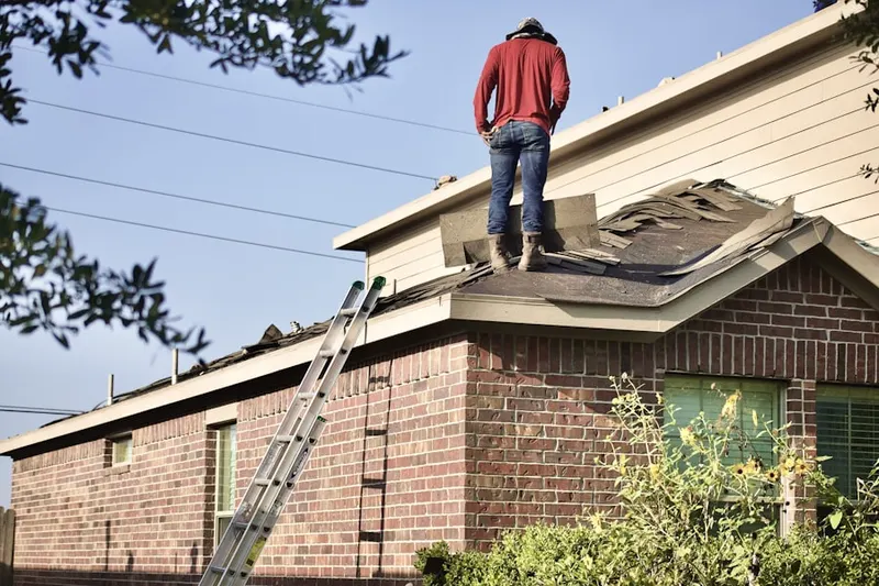 Professional roofer working on a residential roof in Montville